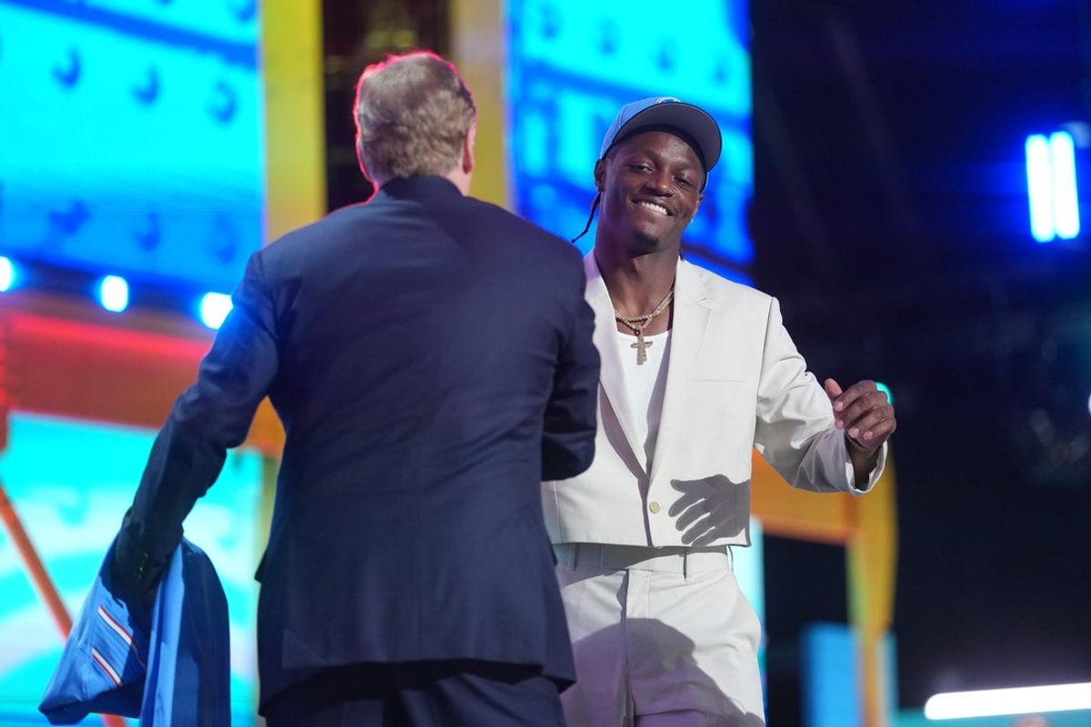 Apr 23, 2026; Pittsburgh, PA, USA; Ohio State Buckeyes receiver Carnell Tate embraces NFL commissioner Roger Goodell after he is selected by the Tennessee Titans as the number four pick during the 2026 NFL Draft at Acrisure Stadium. Mandatory Credit: Kirby Lee-Imagn Images