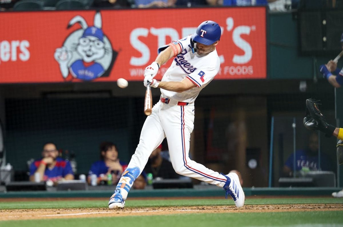 Apr 23, 2026; Arlington, Texas, USA; Texas Rangers center fielder Evan Carter (32) hits a two-run inside the park home run during the third inning against the Pittsburgh Pirates at Globe Life Field. Mandatory Credit: Kevin Jairaj-Imagn Images
