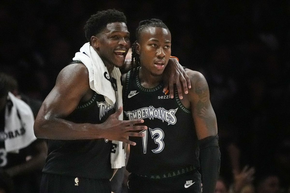 Apr 23, 2026; Minneapolis, Minnesota, USA; Minnesota Timberwolves guard Anthony Edwards (5) talks with guard Ayo Dosunmu (13) during a free throw by the Denver Nuggets in the first quarter at Target Center. Mandatory Credit: Bruce Kluckhohn-Imagn Images