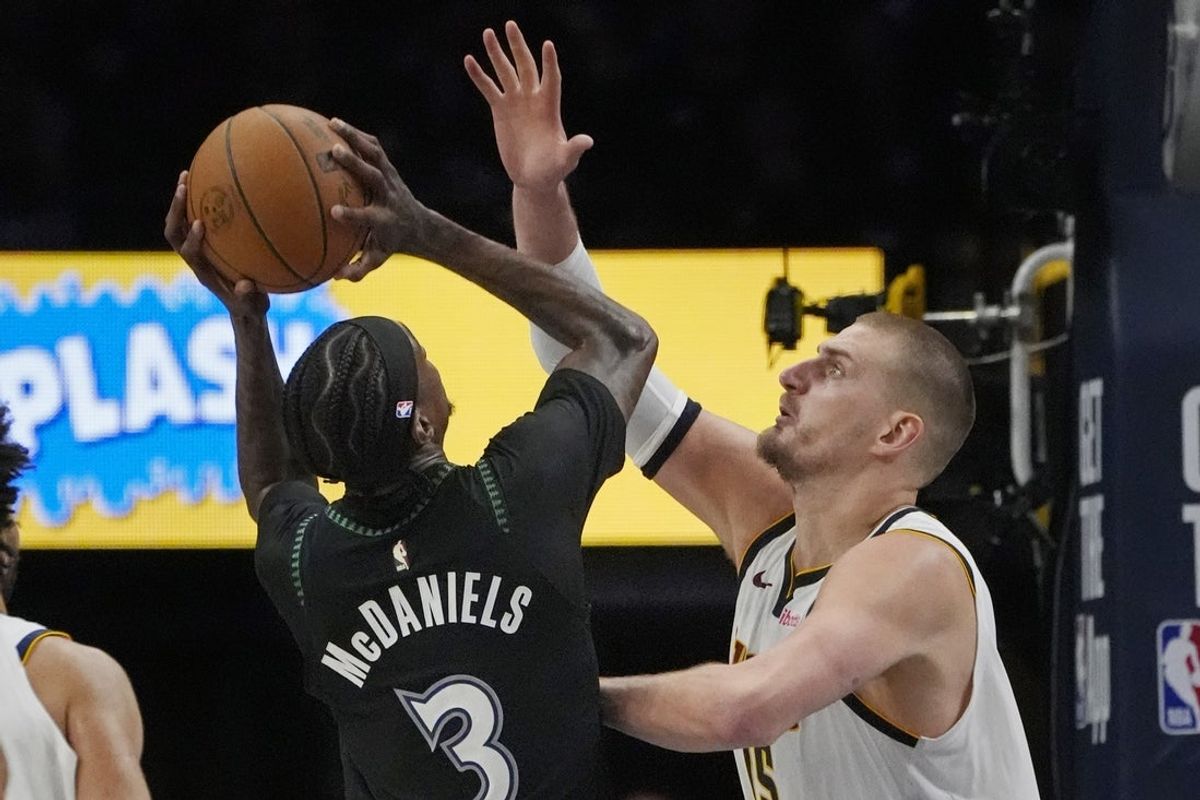 Apr 23, 2026; Minneapolis, Minnesota, USA; Minnesota Timberwolves forward Jaden McDaniels (3) shoots against Denver Nuggets center Nikola Jokic (15) in the fourth quarter at Target Center. Mandatory Credit: Bruce Kluckhohn-Imagn Images