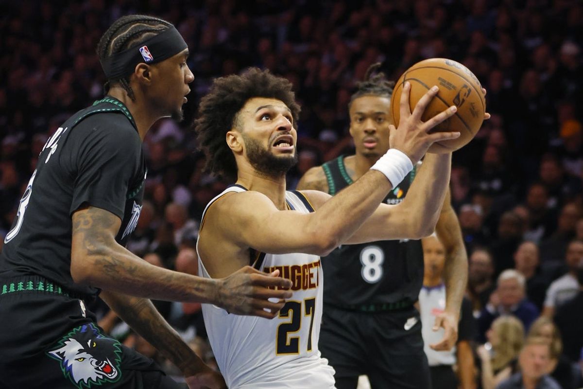 Apr 23, 2026; Minneapolis, Minnesota, USA; Denver Nuggets guard Jamal Murray (27) goes to the basket past Minnesota Timberwolves forward Jaden McDaniels (3) in the fourth quarter at Target Center. Mandatory Credit: Bruce Kluckhohn-Imagn Images