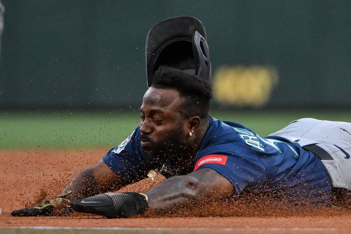 Apr 24, 2026; St. Louis, Missouri, USA; Seattle Mariners left fielder Randy Arozarena (56) loses his helmet as he slides in at third base against the St. Louis Cardinals during the second inning at Busch Stadium. Mandatory Credit: Jeff Curry-Imagn Images