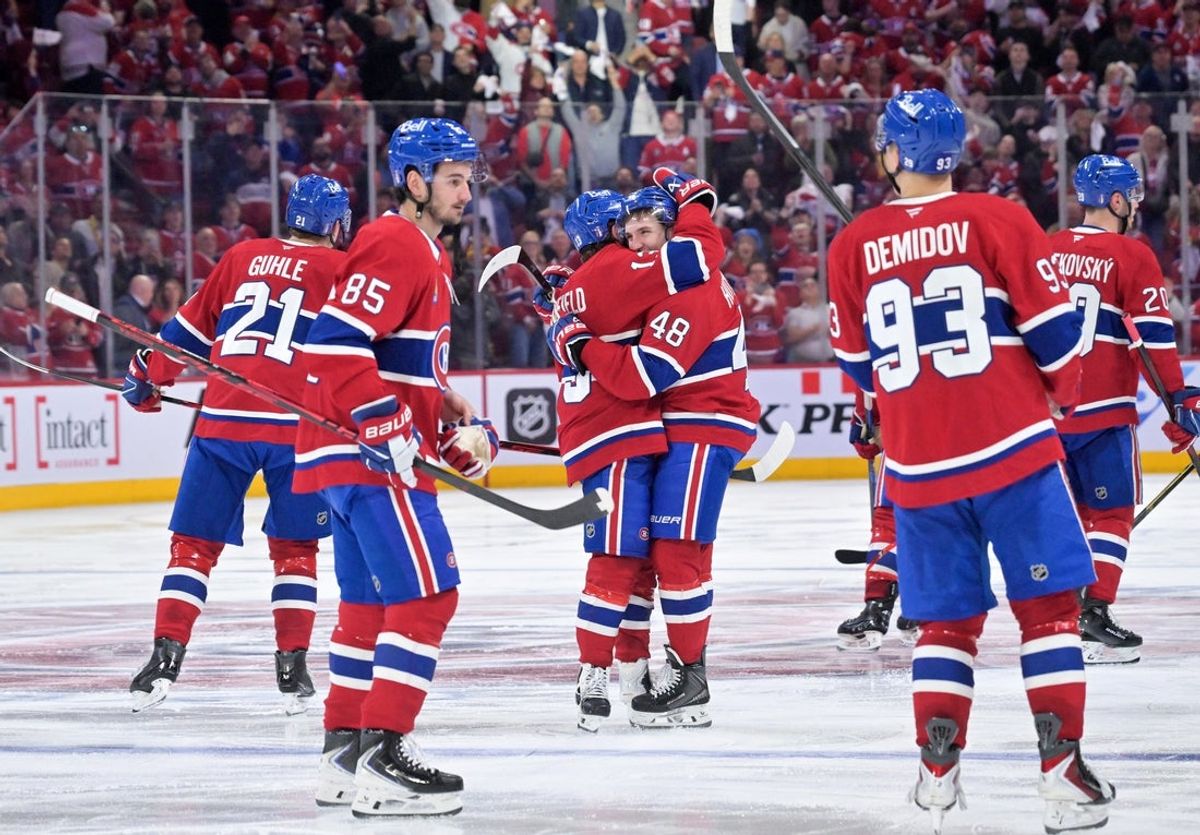 Apr 24, 2026; Montreal, Quebec, CAN; Montreal Canadiens defenseman Lane Hutson (48) celebrates with teammates including forward Cole Caufield (13) after scoring the winning goal against the Tampa Bay Lightning during the overtime period in game three of the first round of the 2026 Stanley Cup Playoffs at the Bell Centre. Mandatory Credit: Eric Bolte-Imagn Images