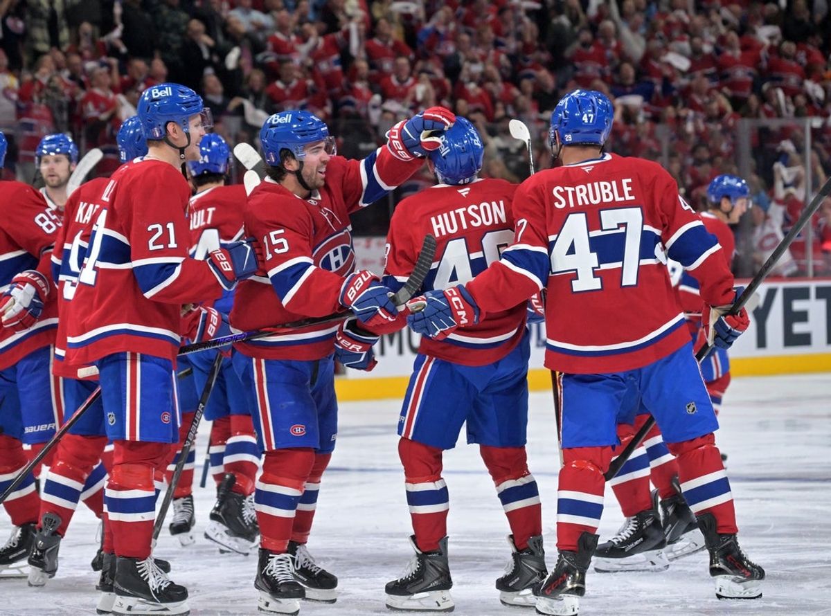 Apr 24, 2026; Montreal, Quebec, CAN; Montreal Canadiens defenseman Lane Hutson (48) celebrates with teammates after scoring the winning goal against the Tampa Bay Lightning during the overtime period in game three of the first round of the 2026 Stanley Cup Playoffs at the Bell Centre. Mandatory Credit: Eric Bolte-Imagn Images