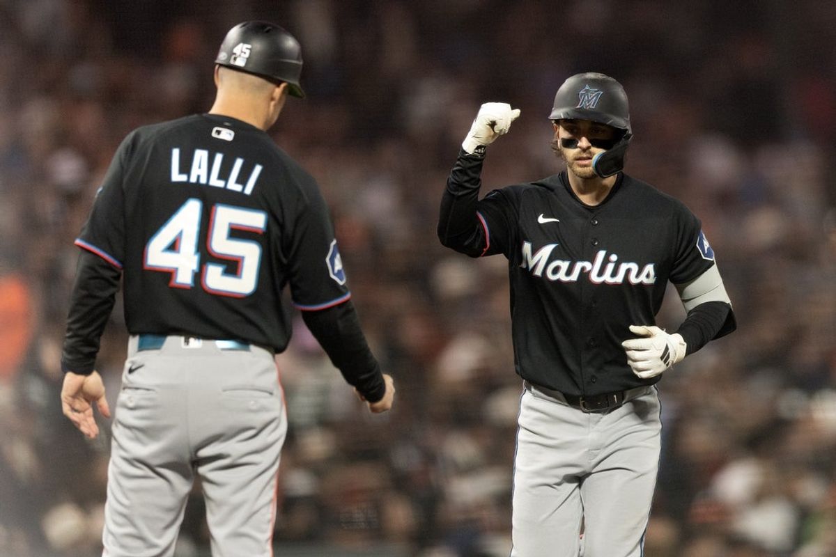 Apr 24, 2026; San Francisco, California, USA; Miami Marlins first baseman Connor Norby (right) gets a congratulatory fist bump from third base coach Blake Lalli (45) as he runs out his three-run home run against the San Francisco Giants during the fourth inning at Oracle Park. Mandatory Credit: D. Ross Cameron-Imagn Images