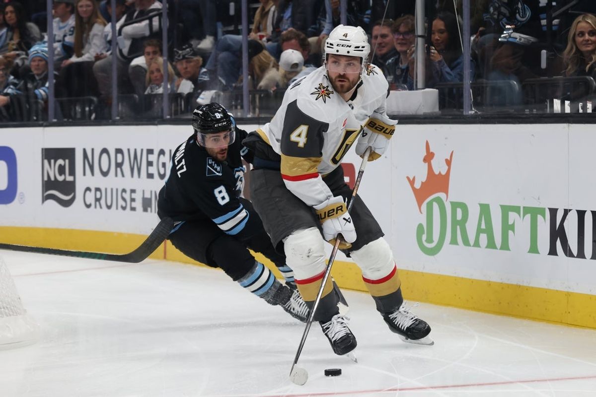 Apr 24, 2026; Salt Lake City, Utah, USA; Vegas Golden Knights defenseman Rasmus Andersson (4) skates with the puck against Utah Mammoth center Nick Schmaltz (8) during the third period in game three of the first round of the 2026 Stanley Cup Playoffs at Delta Center. Mandatory Credit: Rob Gray-Imagn Images