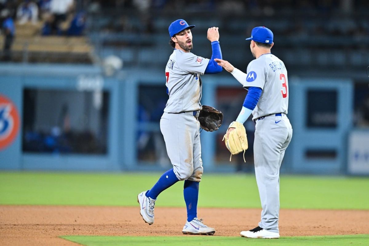 Apr 24, 2026; Los Angeles, California, USA; Chicago Cubs shortstop Dansby Swanson (7) celebrates with Chicago Cubs third baseman Alex Bregman (3) after the game against the Los Angeles Dodgers at Dodger Stadium. Mandatory Credit: William Liang-Imagn Images