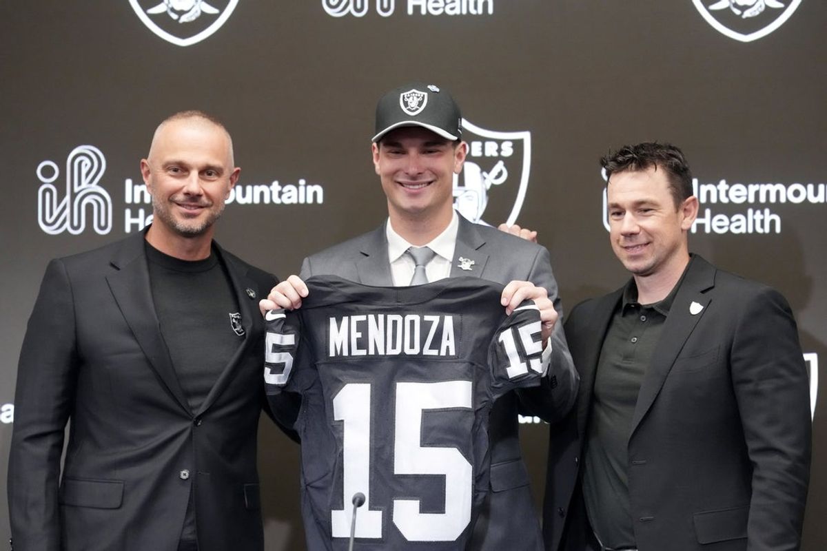 Apr 24, 2026; Henderson, NV, USA; Las Vegas Raiders quarterback Fernando Mendoza (center) poses with jersey with general manager John Spytek (left) and head coach Klint Kubiak  at introductory press conference at Intermountain Health Performance Center after being selected as the No. 1 pick in the 2026 NFL Draft. Mandatory Credit: Kirby Lee-Imagn Images