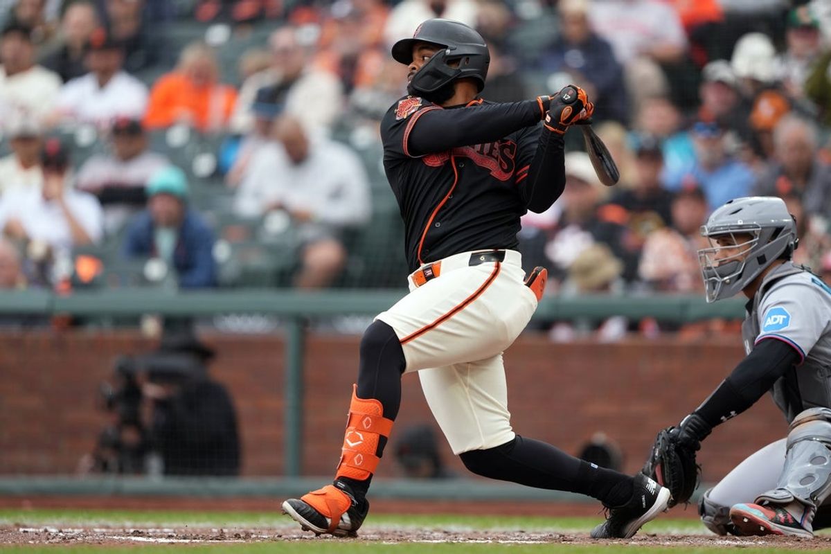 Apr 25, 2026; San Francisco, California, USA; San Francisco Giants left fielder Heliot Ramos (17) hits a home run against the Miami Marlins during the eighth inning at Oracle Park. Mandatory Credit: Darren Yamashita-Imagn Images