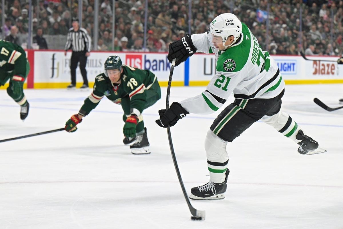 Apr 25, 2026; Saint Paul, Minnesota, USA; Dallas Stars forward Jason Robertson (21) shoots the puck against the Minnesota Wild during the first period in game four of the first round of the 2026 Stanley Cup Playoffs at Grand Casino Arena. Mandatory Credit: Nick Wosika-Imagn Images