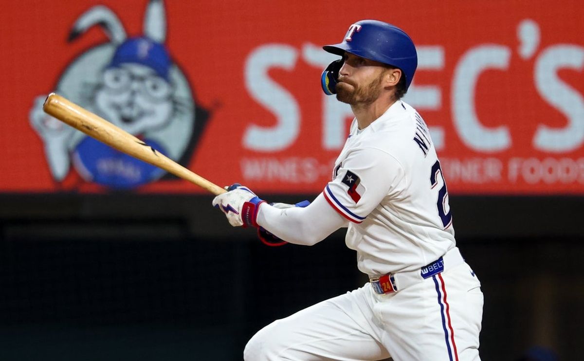 Apr 25, 2026; Arlington, Texas, USA; Texas Rangers right fielder Brandon Nimmo (24) hits an rbi sacrifice fly during the third inning against the Athletics at Globe Life Field. Mandatory Credit: Kevin Jairaj-Imagn Images