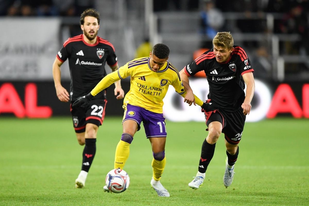 Apr 25, 2026; Washington, District of Columbia, USA; Orlando City SC midfielder Tiago Souza (11) controls the ball defended by D.C. United midfielder Jackson Hopkins (25) during the first half at Audi Field. Mandatory Credit: Hannah Foslien-Imagn Images