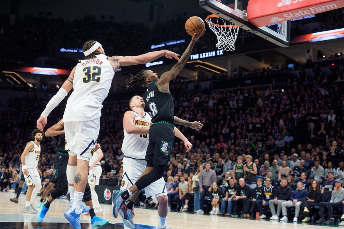 Apr 25, 2026; Minneapolis, Minnesota, USA; Minnesota Timberwolves guard Bones Hyland (8) shoots by the defense of Denver Nuggets forward Aaron Gordon (32) in the second quarter at Target Center. Mandatory Credit: Matt Blewett-Imagn Images