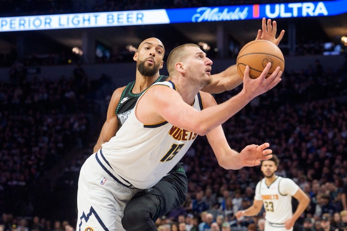 Apr 25, 2026; Minneapolis, Minnesota, USA; Denver Nuggets center Nikola Jokic (15) shoots defended by Minnesota Timberwolves center Rudy Gobert (27) in the third quarter at Target Center. Mandatory Credit: Matt Blewett-Imagn Images