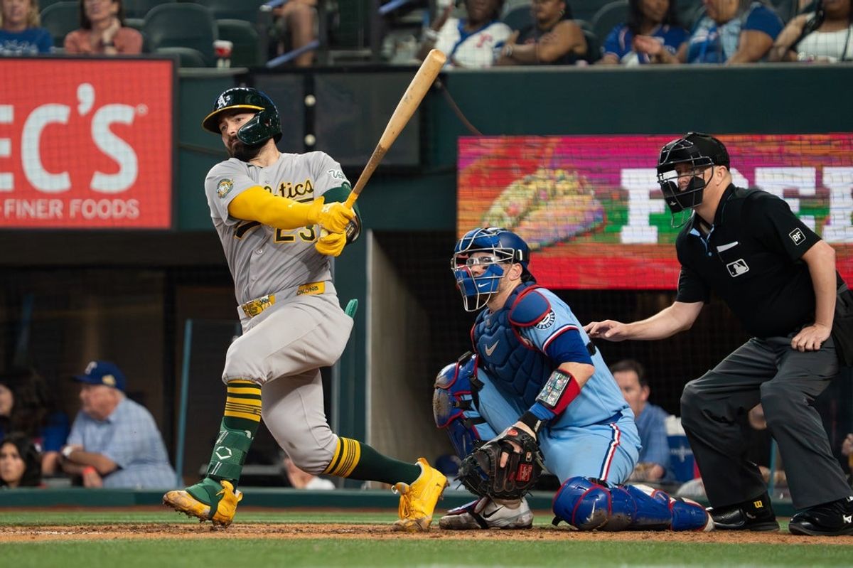 Apr 26, 2026; Arlington, Texas, USA;  Athletics catcher Shea Langeliers (23) hits a double during the fifth inning against the Texas Rangers at Globe Life Field. Mandatory Credit: Raymond Carlin III-Imagn Images