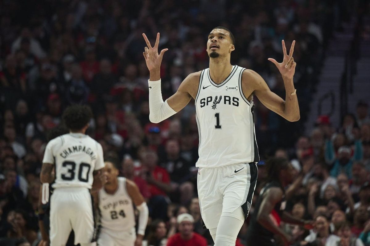 Apr 26, 2026; Portland, Oregon, USA; San Antonio Spurs forward Victor Wembanyama (1) celebrates a three point basket by guard De'aaron Fox (4) during the first half of game four of the first round of the 2026 NBA Playoffs against the Portland Trail Blazers at Moda Center. Mandatory Credit: Troy Wayrynen-Imagn Images
