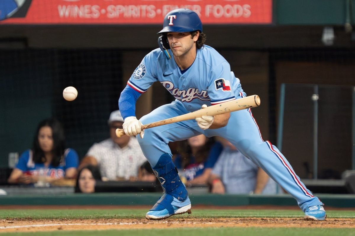 Apr 26, 2026; Arlington, Texas, USA;  Texas Rangers shortstop Josh Smith (8) lays down a bunt single during the sixth inning against the Athletics at Globe Life Field. Mandatory Credit: Raymond Carlin III-Imagn Images