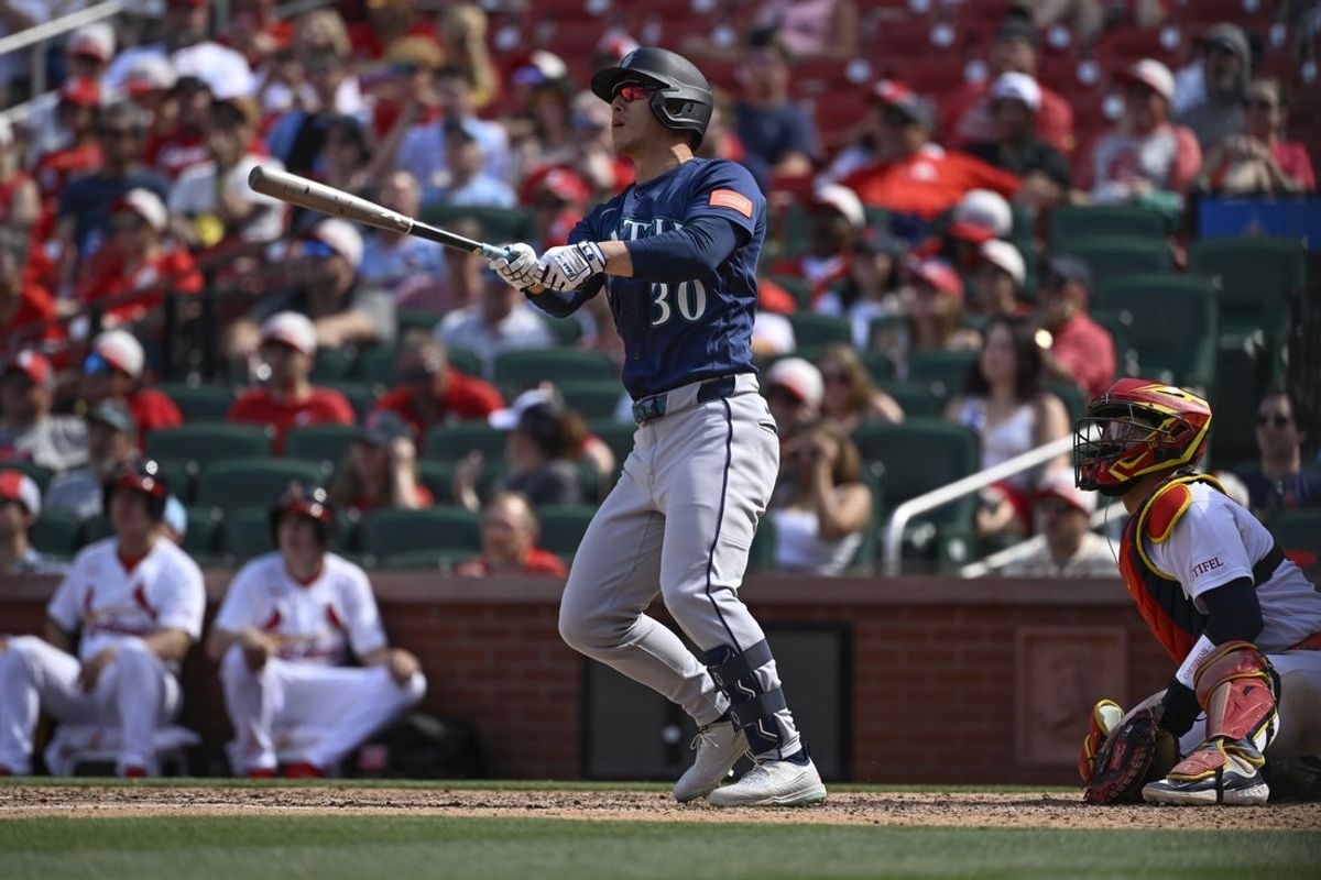 Apr 26, 2026; St. Louis, Missouri, USA; Seattle Mariners pinch hitter Rob Refsnyder (30) hits a solo home run against the St. Louis Cardinals in the ninth inning at Busch Stadium. Mandatory Credit: Joe Puetz-Imagn Images