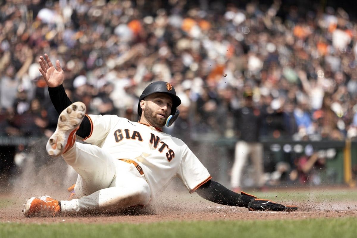 Apr 26, 2026; San Francisco, California, USA; San Francisco Giants designated hitter Casey Schmitt (10) slides safely home on an RBI double by Rafael Devers during the sixth inning against the Miami Marlins at Oracle Park. Mandatory Credit: D. Ross Cameron-Imagn Images