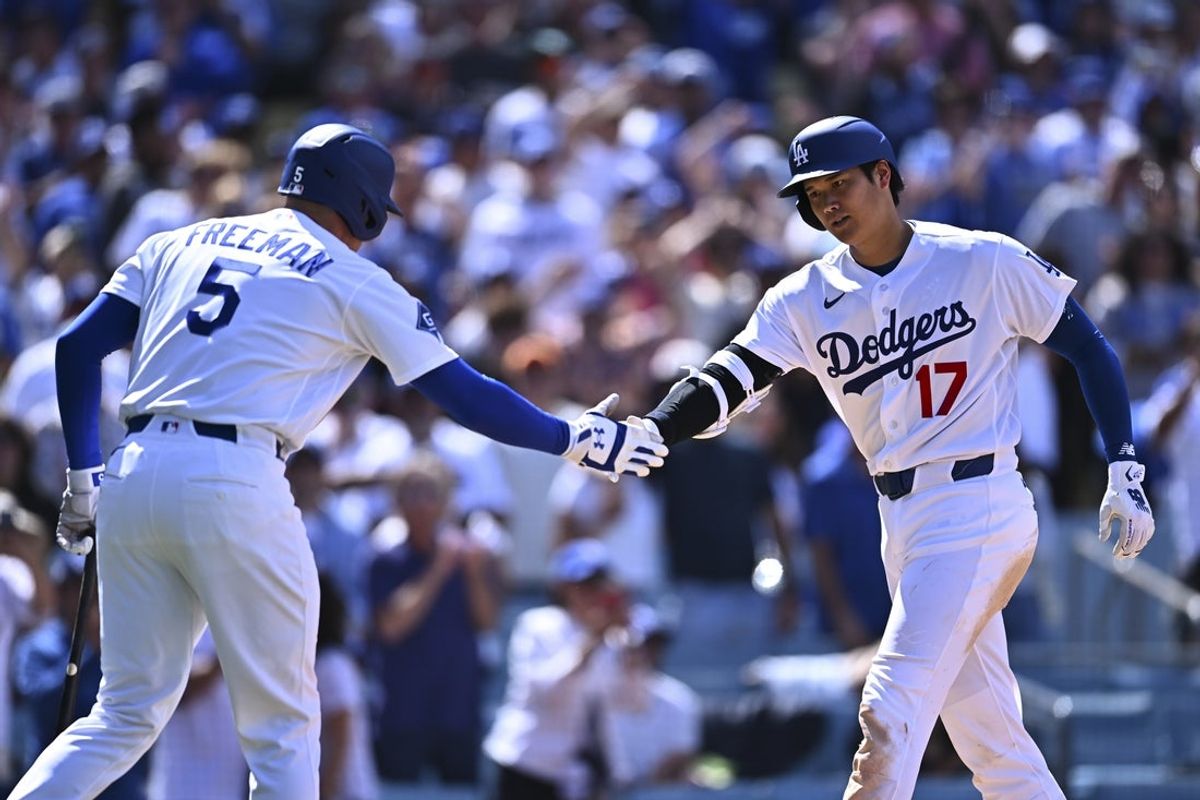 Apr 26, 2026; Los Angeles, California, USA; Los Angeles Dodgers two-way player Shohei Ohtani (17) celebrates with first baseman Freddie Freeman (5) after hitting a solo home run against the Chicago Cubs in the seventh inning at Dodger Stadium. Mandatory Credit: Jonathan Hui-Imagn Images