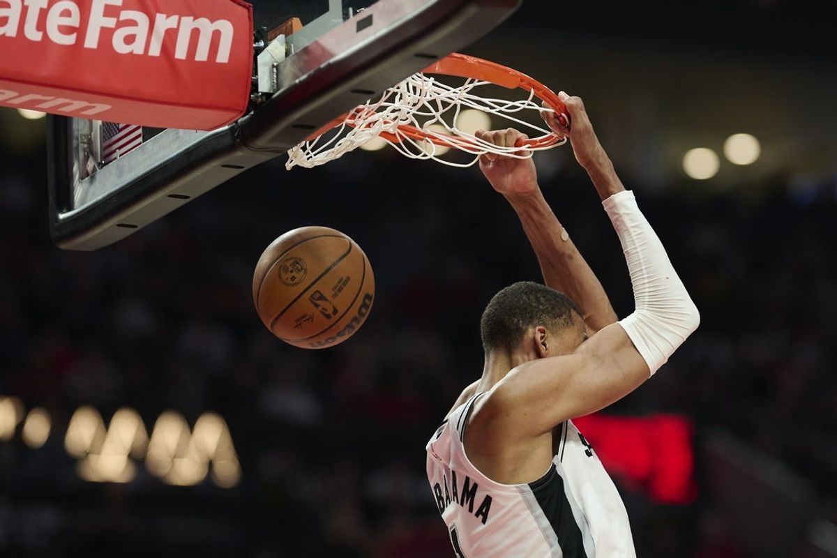 Apr 26, 2026; Portland, Oregon, USA; San Antonio Spurs forward Victor Wembanyama (1) reverse dunks the basketball during the second half against the Portland Trail Blazers during game four of the first round of the 2026 NBA Playoffs at Moda Center. Mandatory Credit: Troy Wayrynen-Imagn Images