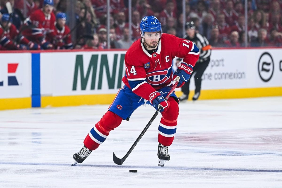 Apr 26, 2026; Montreal, Quebec, CAN; Montreal Canadiens center Nick Suzuki (14) crosses the blue line with the puck during the first period in game four of the first round of the 2026 Stanley Cup Playoffs at Bell Centre. Mandatory Credit: David Kirouac-Imagn Images