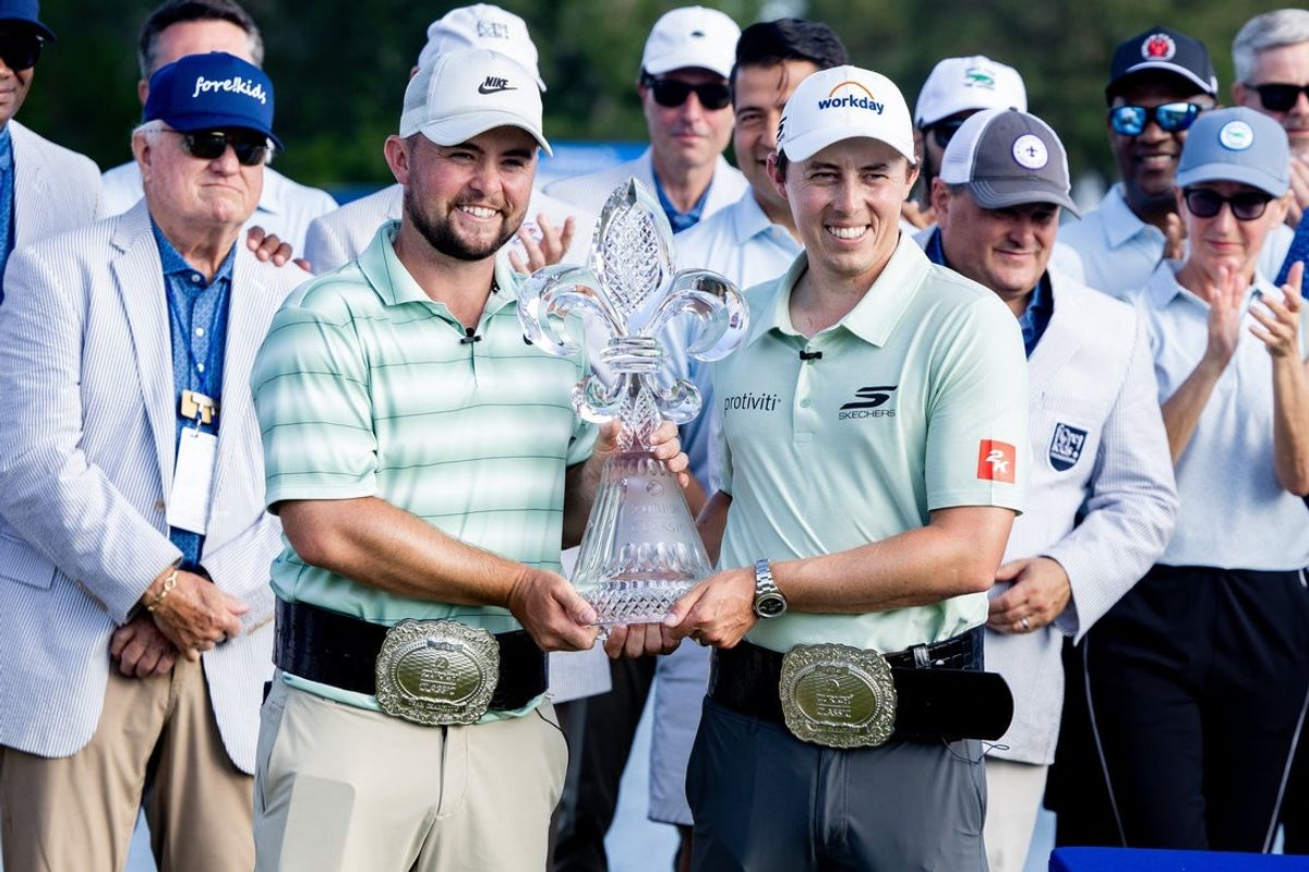 Apr 26, 2026; Avondale, Louisiana, USA;  Matt Fitzpatrick (right) and Alex (left) pose for pictures with the Zurich Classic trophy after the final round of the Zurich Classic of New Orleans golf tournament. Mandatory Credit: Stephen Lew-Imagn Images