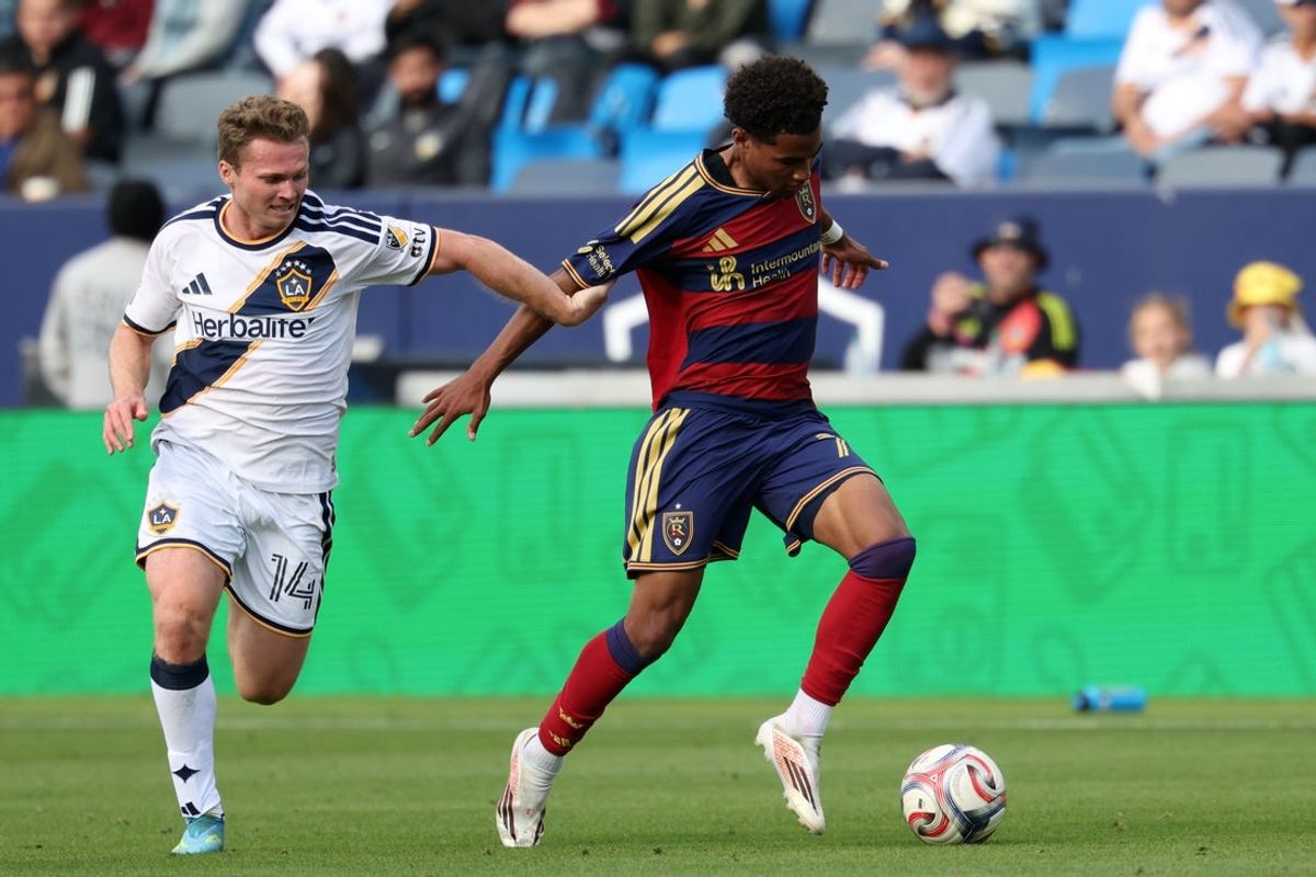 Apr 26, 2026; Carson, California, USA;  Real Salt Lake midfielder Zavier Gozo (72) fights for the ball against LA Galaxy defender John Nelson (14) during the second half at Dignity Health Sports Park. Mandatory Credit: Kiyoshi Mio-Imagn Images