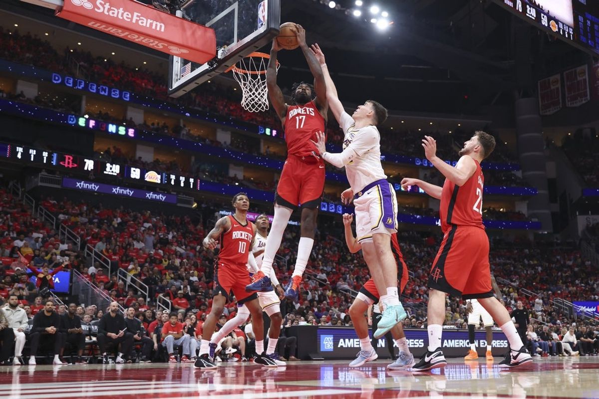 Apr 26, 2026; Houston, Texas, USA; Houston Rockets forward Tari Eason (17) gets a rebound away from Los Angeles Lakers forward Jake LaRavia (12) during the third quarter during game four of the first round of the 2026 NBA Playoffs at Toyota Center. Mandatory Credit: Troy Taormina-Imagn Images