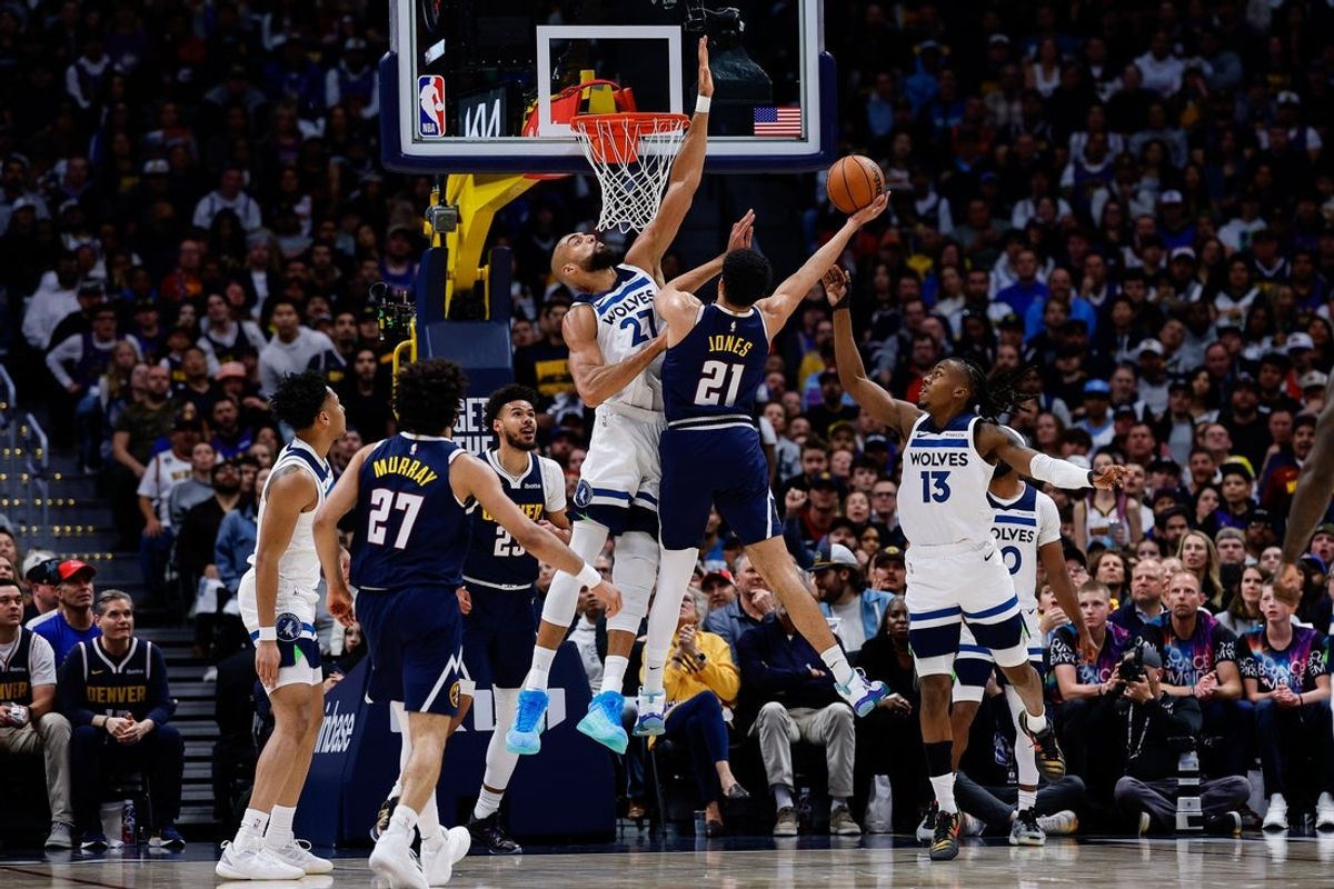 Apr 27, 2026; Denver, Colorado, USA; Denver Nuggets forward Spencer Jones (21) drives to the net against Minnesota Timberwolves center Rudy Gobert (27) and guard Ayo Dosunmu (13) as forward Cameron Johnson (23) and guard Jamal Murray (27) and guard Terrence Shannon Jr. (1) defend in the first quarter during game five of the first round of the 2026 NBA Playoffs at Ball Arena. Mandatory Credit: Isaiah J. Downing-Imagn Images