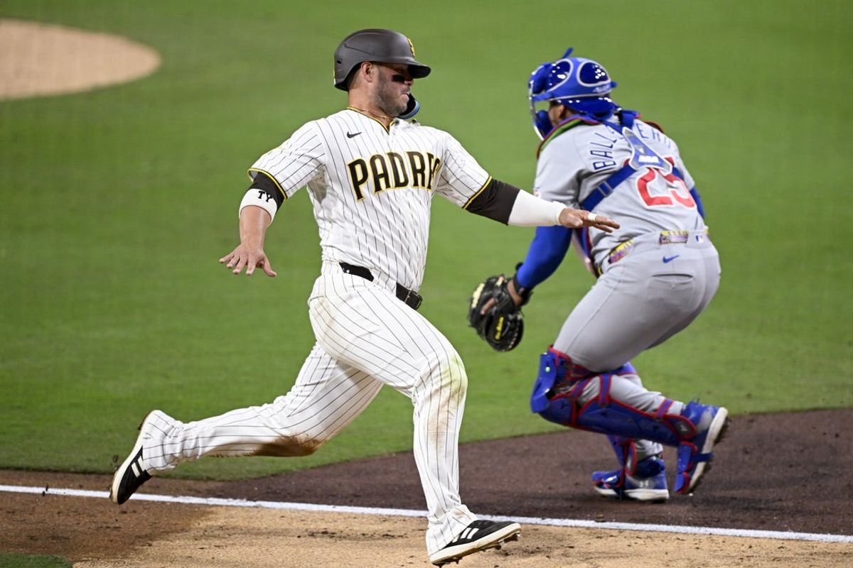 Apr 27, 2026; San Diego, California, USA; San Diego Padres first baseman Ty France (25) scores ahead of the throw to Chicago Cubs catcher Moises Ballesteros (25) during the fifth inning at Petco Park. Mandatory Credit: Denis Poroy-Imagn Images
