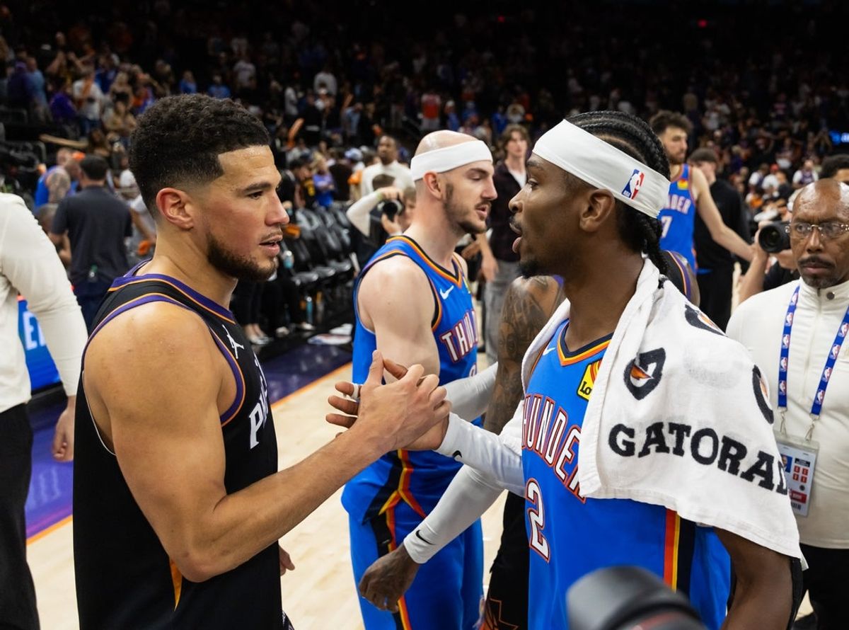 Apr 27, 2026; Phoenix, Arizona, USA; Oklahoma City Thunder guard Shai Gilgeous-Alexander (2) greets Phoenix Suns guard Devin Booker (1) after advancing in a four game sweep of the first round of the 2026 NBA Playoffs at Mortgage Matchup Center. Mandatory Credit: Mark J. Rebilas-Imagn Images