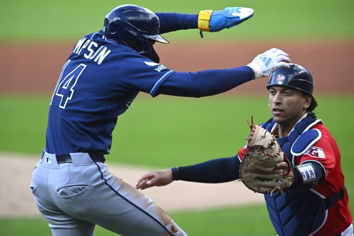 Apr 28, 2026; Cleveland, Ohio, USA; Tampa Bay Rays left fielder Chandler Simpson (14) is tagged out by Cleveland Guardians catcher Bo Naylor (23) while attempting to score from third base on a ground ball in the first inning at Progressive Field. Mandatory Credit: David Richard-Imagn Images