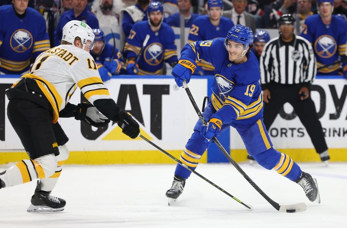 Apr 28, 2026; Buffalo, New York, USA; Boston Bruins center Casey Mittelstadt (11) tries to block a shot by Buffalo Sabres center Peyton Krebs (19) during overtime in game five of the first round of the 2026 Stanley Cup Playoffs at KeyBank Center. Mandatory Credit: Timothy T. Ludwig-Imagn Images