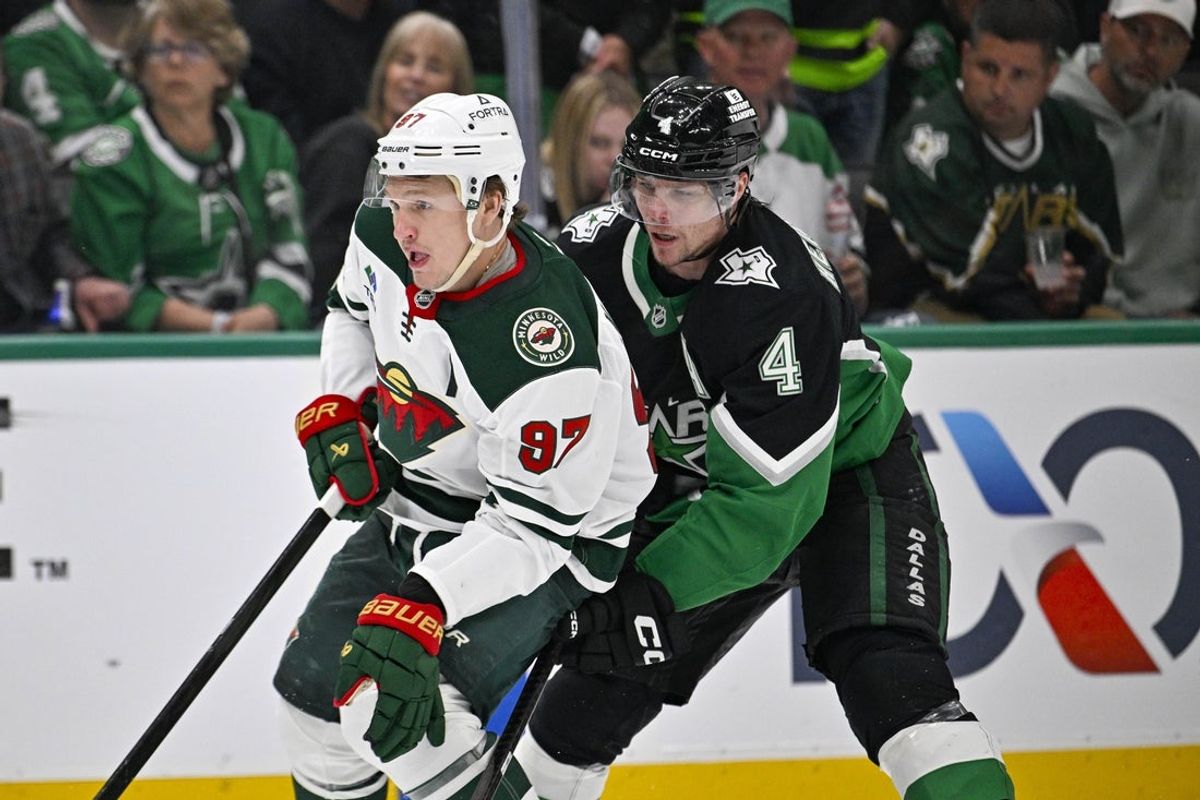 Apr 28, 2026; Dallas, Texas, USA; Minnesota Wild left wing Kirill Kaprizov (97) skates with the puck past Dallas Stars defenseman Miro Heiskanen (4) and scores an empty net goal during the third period in game five of the first round of the 2026 Stanley Cup Playoffs at American Airlines Center. Mandatory Credit: Jerome Miron-Imagn Images