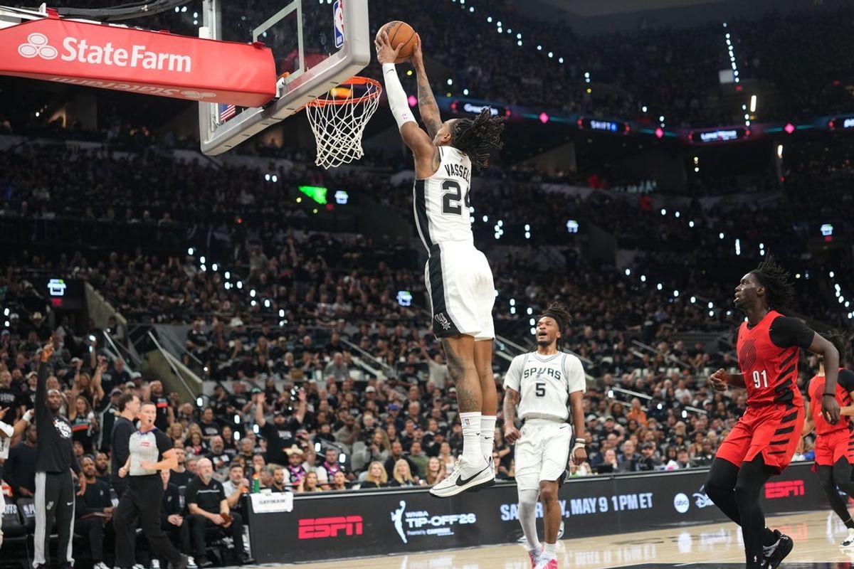 Apr 28, 2026; San Antonio, Texas, USA; San Antonio Spurs guard Devin Vassell (24) dunks ahead of Portland Trail Blazers forward Sidy Cissoko (91) during the first half of game five of the first round of the 2026 NBA Playoffs at Frost Bank Center. Mandatory Credit: Scott Wachter-Imagn Images