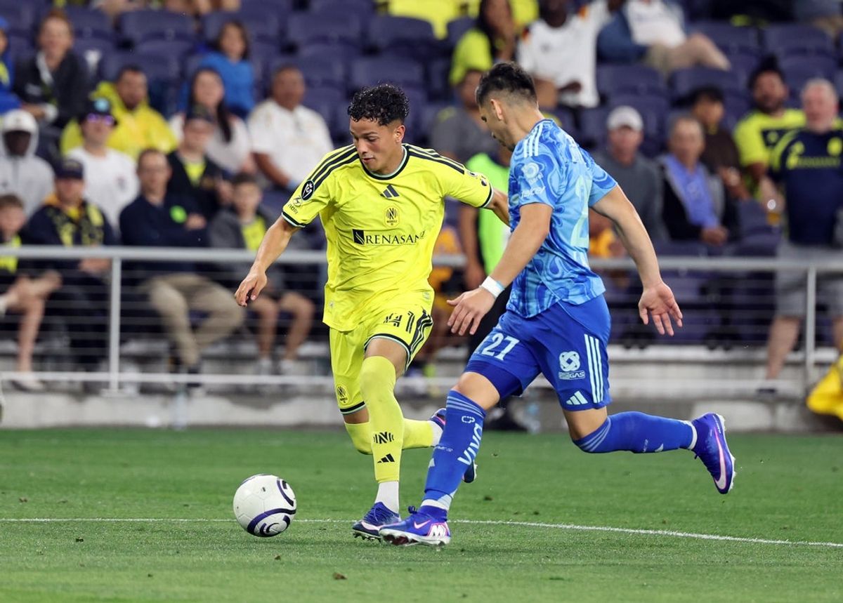 Apr 28, 2026; Nashville, TN, USA; Nashville SC forward Warren Madrigal (41) dribbles the ball as Tigres UANL defender Jesus Angulo (27) defends during the second half of their Concacaf Champions Cup Semifinals game at GEODIS Park. Mandatory Credit: Alan Poizner-Imagn Images