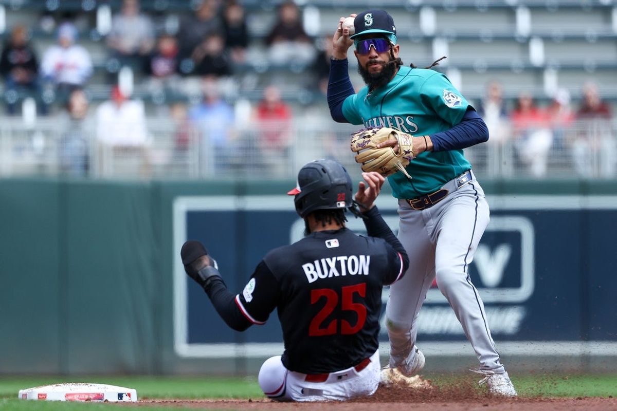 Apr 29, 2026; Minneapolis, Minnesota, USA; Seattle Mariners shortstop J.P. Crawford (3) turns a double play on a ball hit by Minnesota Twins left fielder Trevor Larnach (9) during the third inning at Target Field. Mandatory Credit: Matt Krohn-Imagn Images
