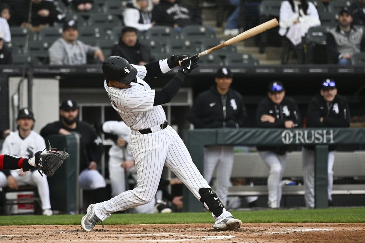 Apr 29, 2026; Chicago, Illinois, USA;  Chicago White Sox third baseman Miguel Vargas (20) hits a RBI single against the Los Angeles Angels during the third inning at Rate Field. Mandatory Credit: Matt Marton-Imagn Images