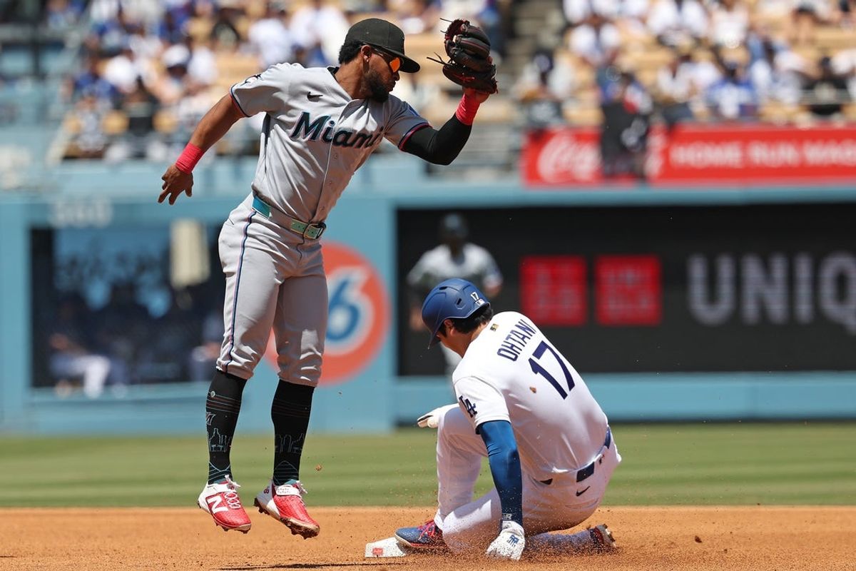 Apr 29, 2026; Los Angeles, California, USA; Los Angeles Dodgers two-way player Shohei Ohtani (17) slides safely in front of the tag by Miami Marlins shortstop Otto Lopez (6) during the second inning at Dodger Stadium. Mandatory Credit: Kiyoshi Mio-Imagn Images