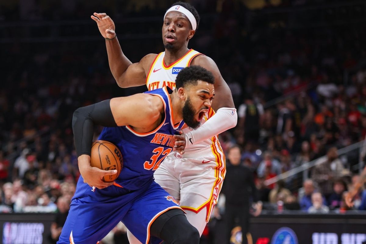 Apr 30, 2026; Atlanta, Georgia, USA; New York Knicks center Karl-Anthony Towns (32) drives past Atlanta Hawks forward Onyeka Okongwu (17) in the first quarter during game six of the first round of the 2026 NBA Playoffs at State Farm Arena. Mandatory Credit: Brett Davis-Imagn Images