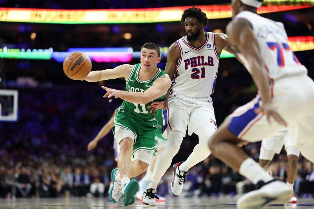 Apr 30, 2026; Philadelphia, Pennsylvania, USA; Boston Celtics guard Payton Pritchard (11) passes the ball in front of Philadelphia 76ers center Joel Embiid (21) during the second quarter at Xfinity Mobile Arena. Mandatory Credit: Bill Streicher-Imagn Images