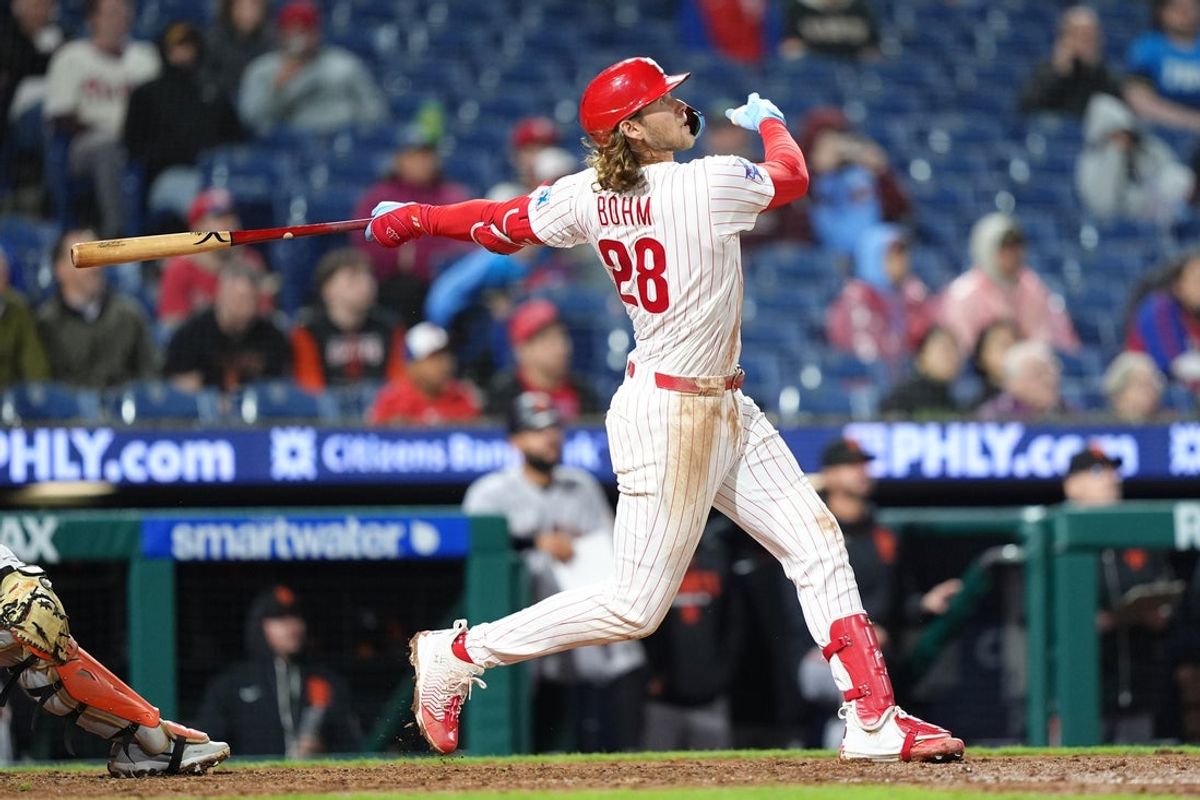 Apr 30, 2026; Philadelphia, Pennsylvania, USA; Philadelphia Phillies infielder Alec Bohm (28) hits a sacrifice fly against the San Francisco Giants in the tenth inning at Citizens Bank Park. Mandatory Credit: Kyle Ross-Imagn Images