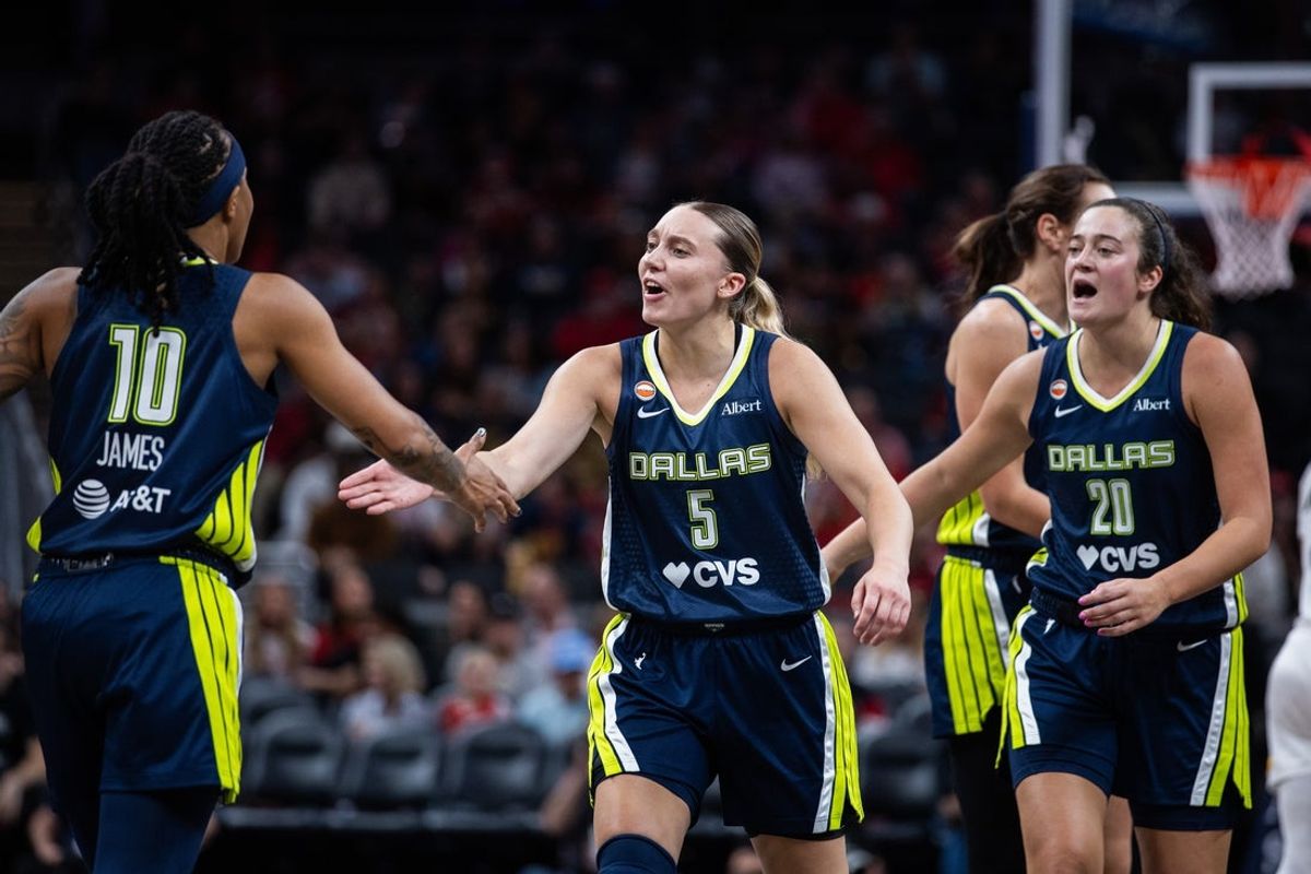 Apr 30, 2026; Indianapolis, IN, USA;  Dallas Wings guard Paige Bueckers (5) celebrates during a timeout in the first half against the Indiana Fever at the Gainbridge Fieldhouse. Mandatory Credit: Trevor Ruszkowski-Imagn Images