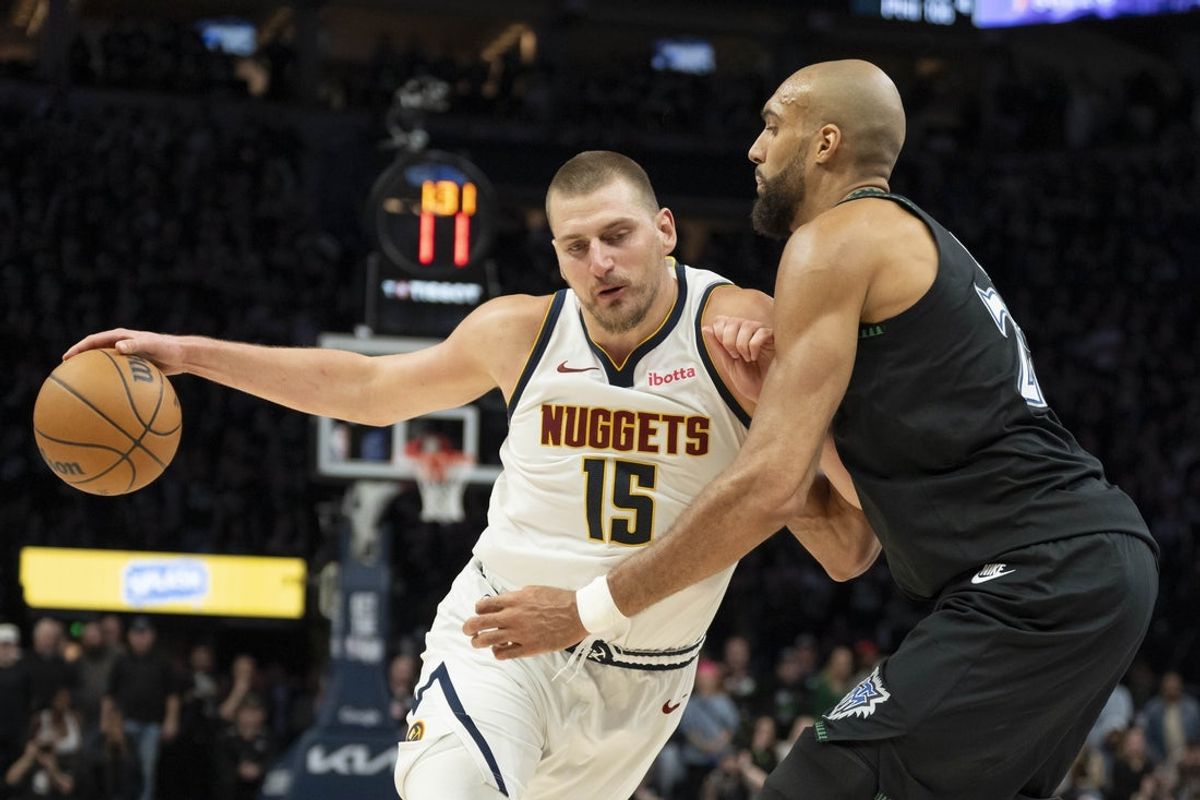Apr 30, 2026; Minneapolis, Minnesota, USA; Denver Nuggets center Nikola Jokic (15) dribbles the ball as Minnesota Timberwolves center Rudy Gobert (27) played defense in the second half during game six of the first round of the 2026 NBA Playoffs at Target Center. Mandatory Credit: Jesse Johnson-Imagn Images