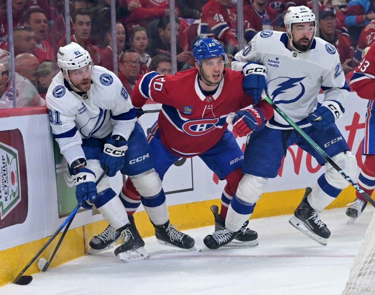 May 1, 2026; Montreal, Quebec, CAN; Tampa Bay Lightning defenseman Erik Cernak (81) and teammate forward Nick Paul (20) contain Montreal Canadiens forward Juraj Slafkovsky (20) during the first period in game six of the first round of the 2026 Stanley Cup Playoffs at the Bell Centre. Mandatory Credit: Eric Bolte-Imagn Images