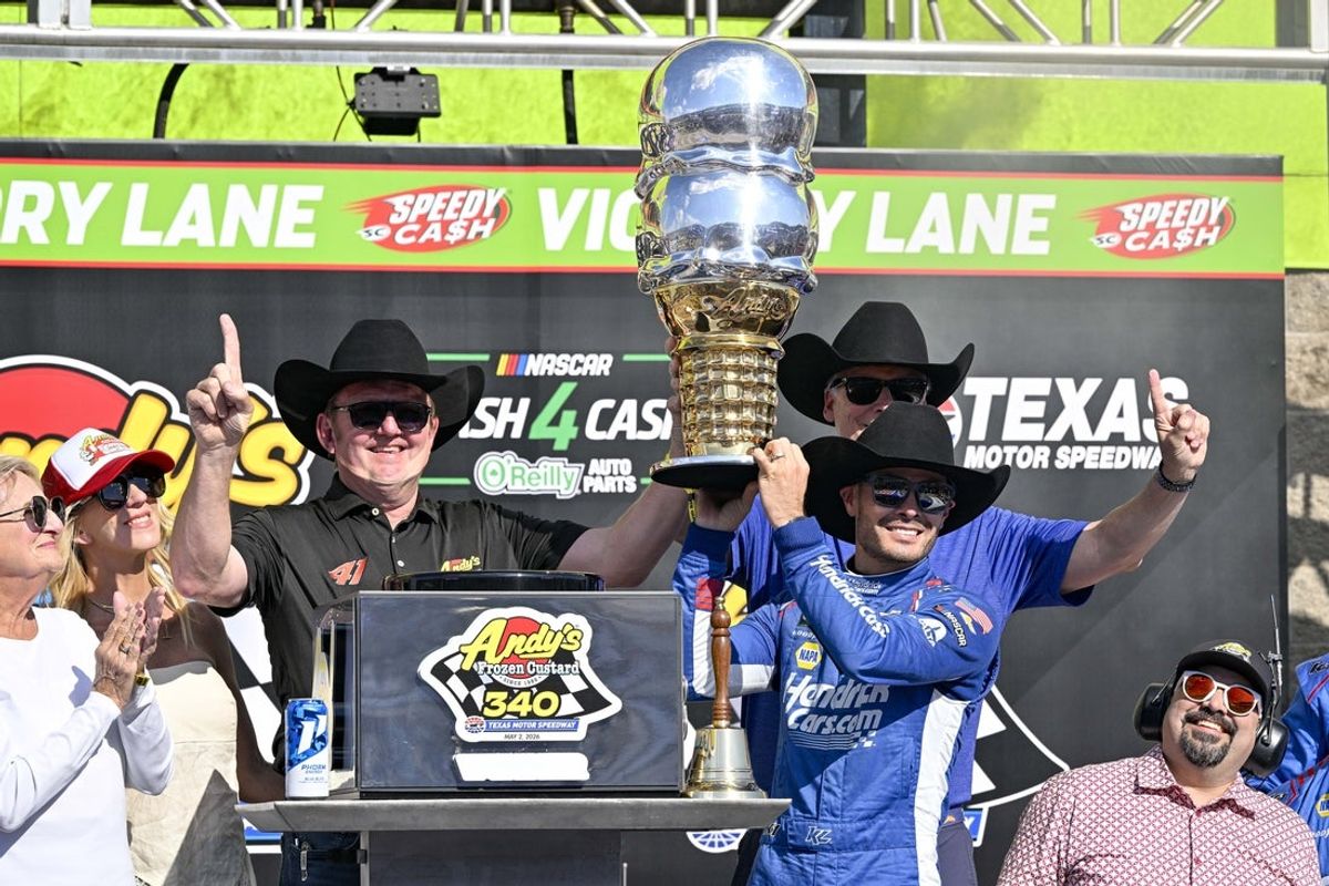 May 2, 2026; Fort Worth, Texas, USA; JR Motorsports driver Kyle Larson (88) celebrates in victory lane with the trophy after he wins the 2026 Andy's Frozen Custard 340 at Texas Motor Speedway. Mandatory Credit: Jerome Miron-Imagn Images