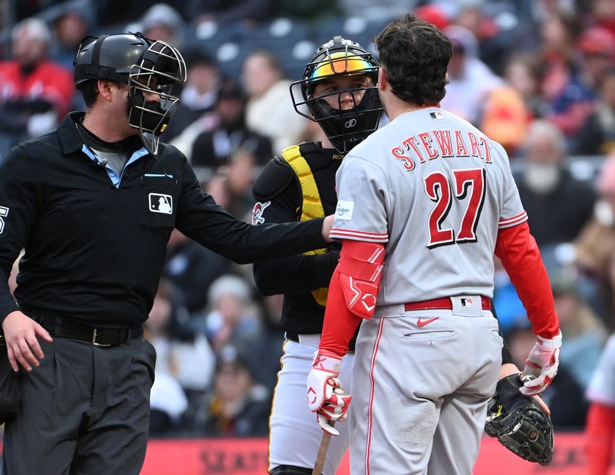 May 2, 2026; Pittsburgh, Pennsylvania, USA;  Home plate umpire Willie Traynow keeps Cincinnati Reds second baseman Sal Stewart (27) away from Pittsburgh Pirates cvatcher Henry Davis after he was nearly hit by the ball during the seventh inning at PNC Park. Mandatory Credit: Philip G. Pavely-Imagn Images