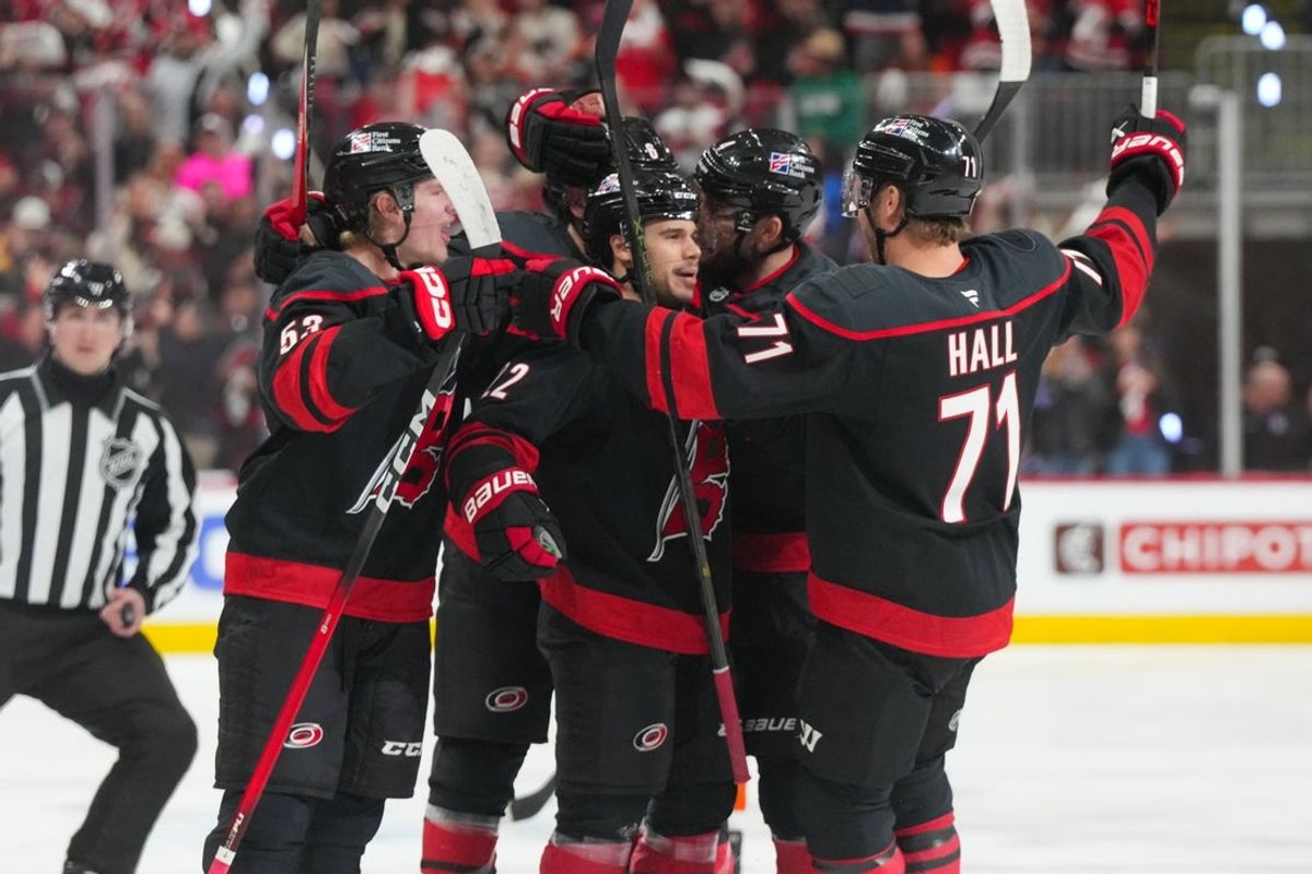 May 2, 2026; Raleigh, North Carolina, USA;  Carolina Hurricanes center Logan Stankoven (22) is congratulated by left wing Taylor Hall (71) and right wing Jackson Blake (53) after his goal against the Philadelphia Flyers during the first period at Lenovo Center. Mandatory Credit: James Guillory-Imagn Images