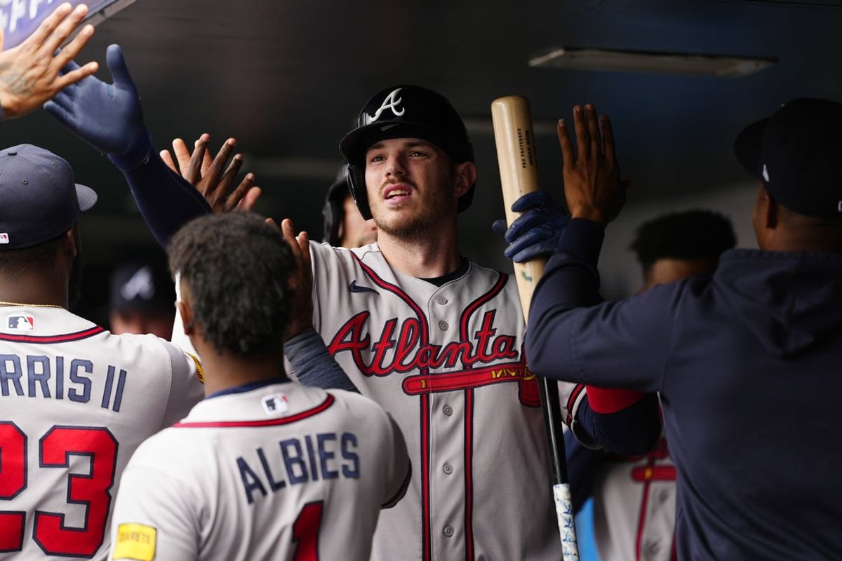 May 3, 2026; Denver, Colorado, USA; Atlanta Braves catcher Jonah Heim (20) celebrates scoring a run after his sacrifice fly in the  fifth inning against the Colorado Rockies at Coors Field. Mandatory Credit: Ron Chenoy-Imagn Images